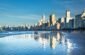 Stunning view of Balneário Camboriú's modern skyline reflecting on the beach at daytime.